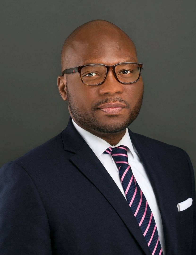 A man in a suit and tie standing up.