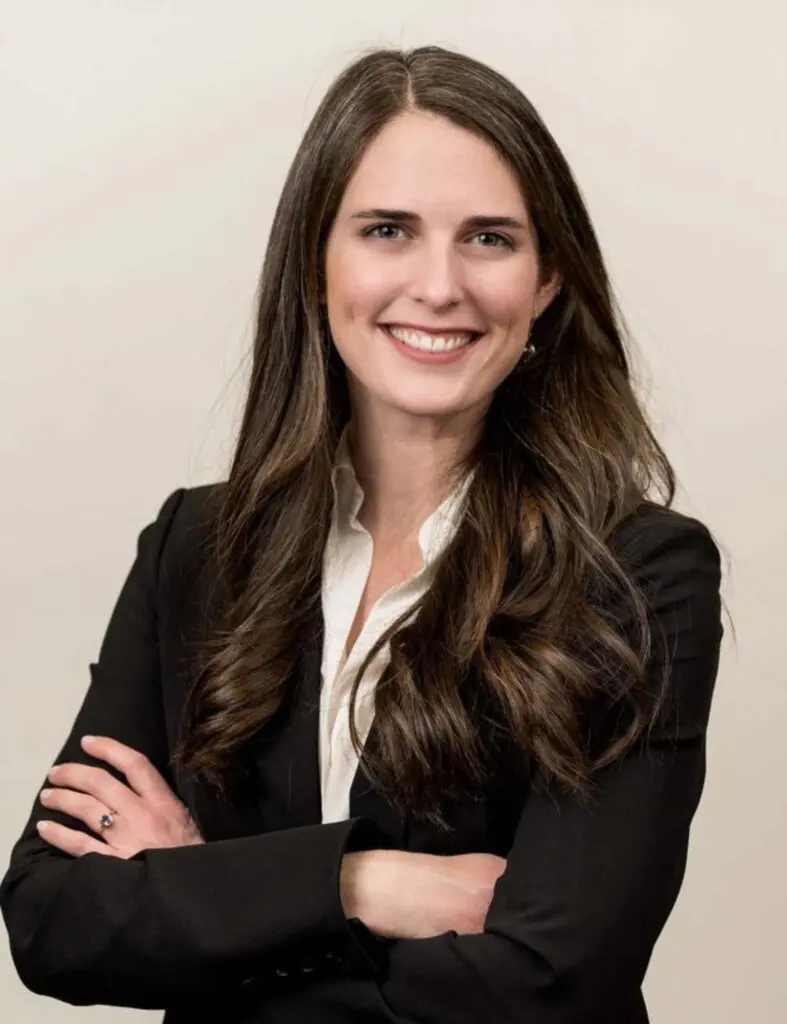 A woman in black jacket smiling for the camera.